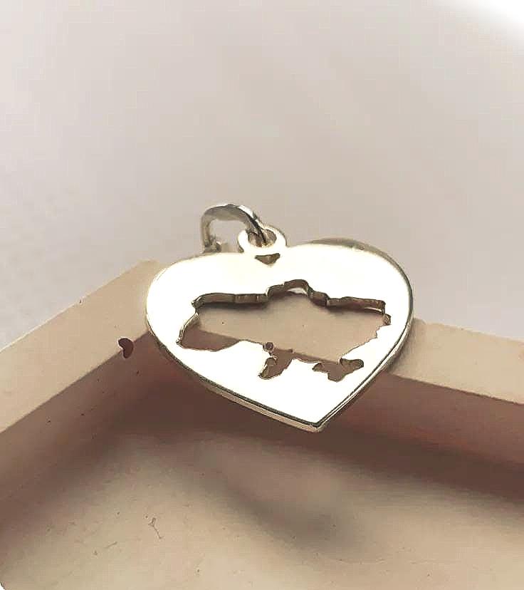 Heart-shaped pendant with a map design on a white background